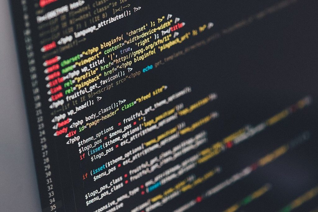 A programmer working on open-source code at a desk