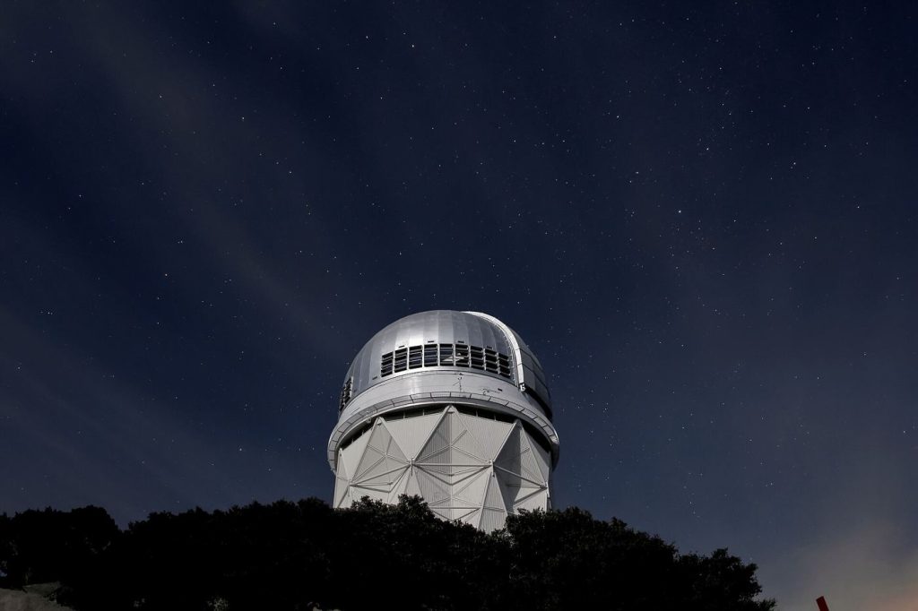A telescope under a starry sky