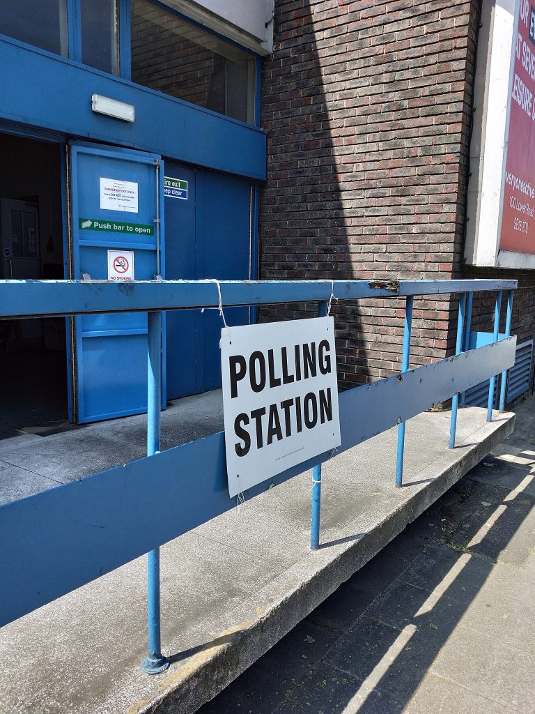 Voters casting ballots at a polling station during an election